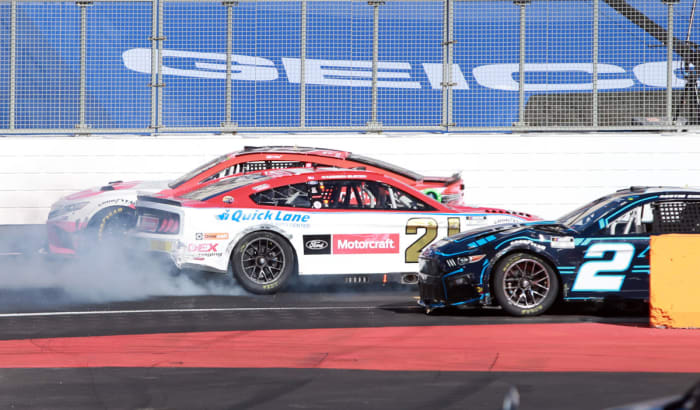 Bubba Wallace, driver of the #23 DoorDash Toyota, Harrison Burton, driver of the #21 Motorcraft/Quick Lane Ford, and Austin Cindric, driver of the #2 eCascadia Ford, are involved in an incident during the last chance qualifying race prior to the NASCAR Cup Series Busch Light Clash at the Los Angeles Memorial Coliseum . (Photo by Sean Gardner/Getty Images)